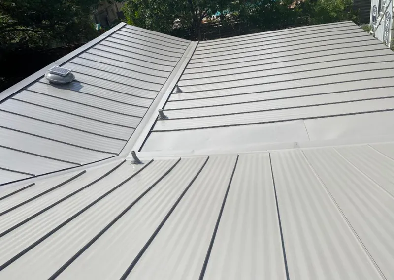 Solar attic fan installed on a metal roof for Roof Ventilation in Broadview Heights